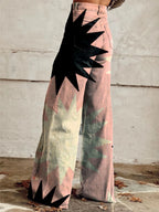 Close-up of pink bohemian chic high-waisted pants with a black star print, back view