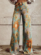 Close-up of teal palazzo pants with a yellow and orange daisy print, front view