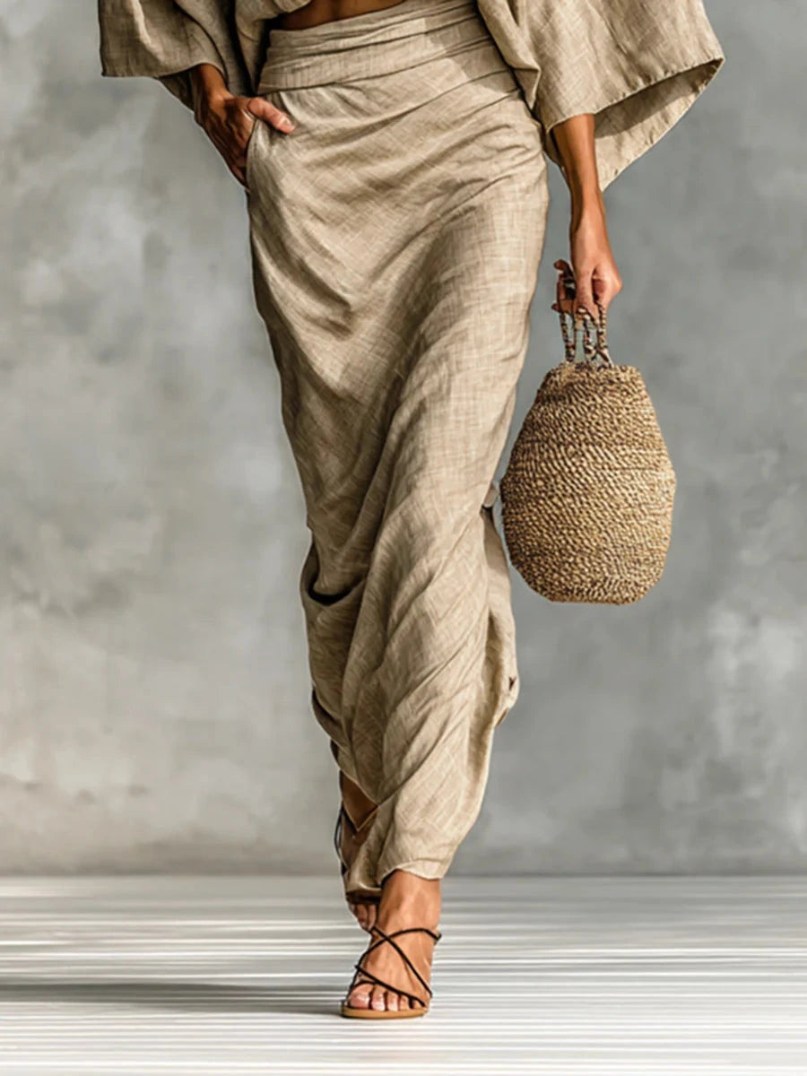 Woman wearing a khaki two-piece coordinating outfit, side view showing the wrap skirt