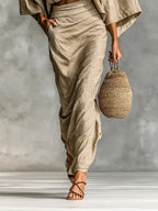 Woman wearing a khaki two-piece coordinating outfit, side view showing the wrap skirt