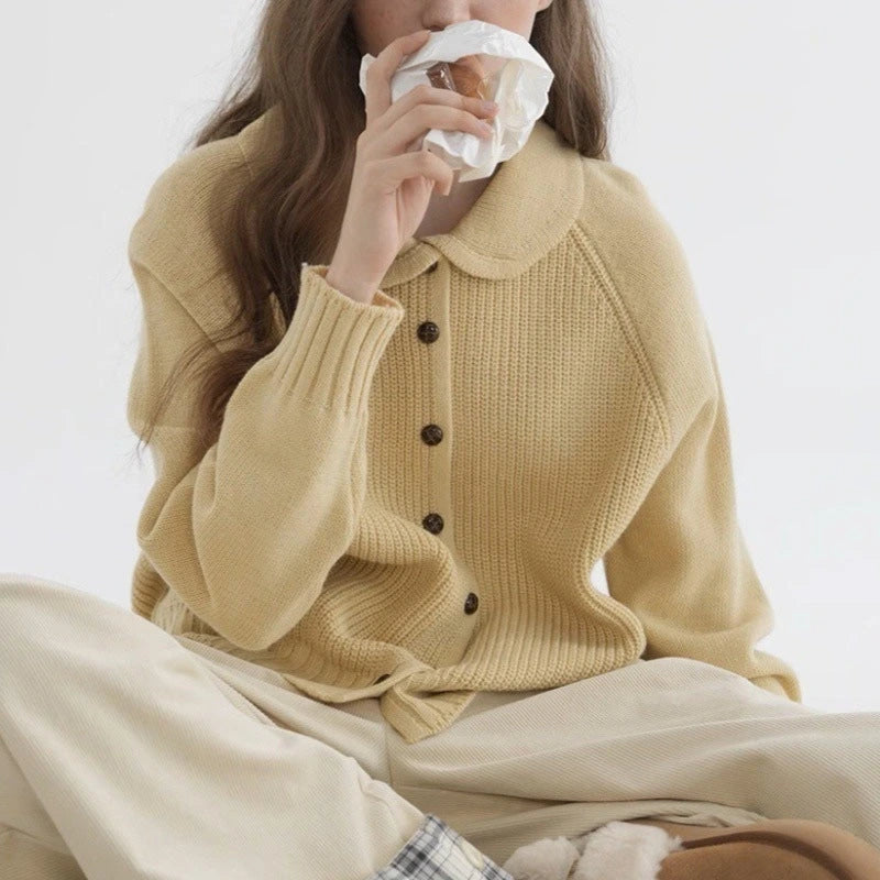 Woman wearing a yellow button-up collared sweater in a lifestyle setting