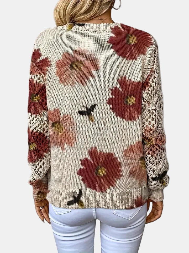 Woman wearing a red floral v-neck long sleeve sweater in a casual indoor setting