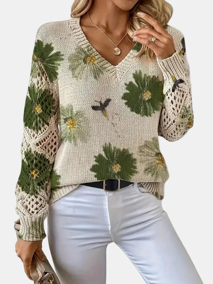 Woman wearing a green floral v-neck long sleeve sweater in a studio setting, alternate pose