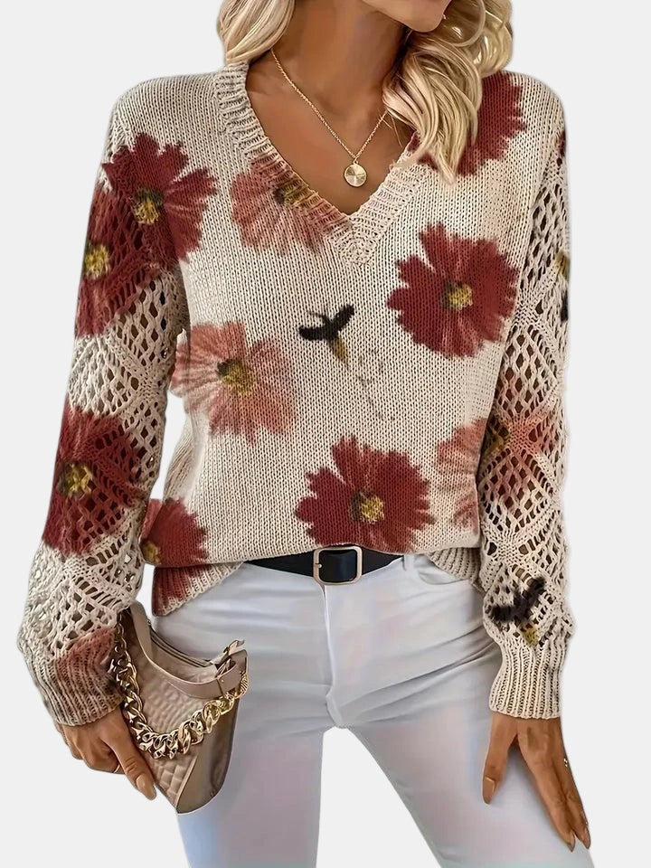 Close-up of a red floral v-neck long sleeve sweater showing the long sleeve cuff detail