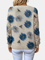 Close-up of a blue floral v-neck long sleeve sweater showing the floral pattern on the sleeve