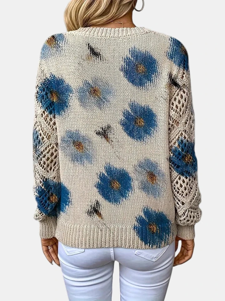 Close-up of a blue floral v-neck long sleeve sweater showing the floral pattern on the sleeve