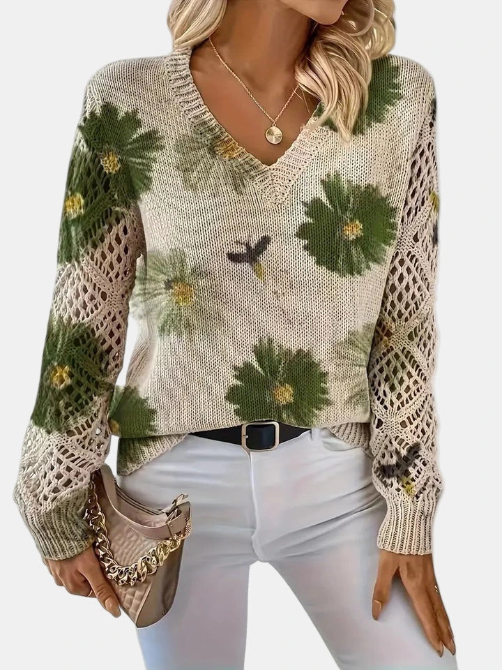 Woman wearing a green floral v-neck long sleeve sweater in an outdoor urban setting