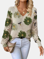 Woman wearing a green floral v-neck long sleeve sweater in a lifestyle setting