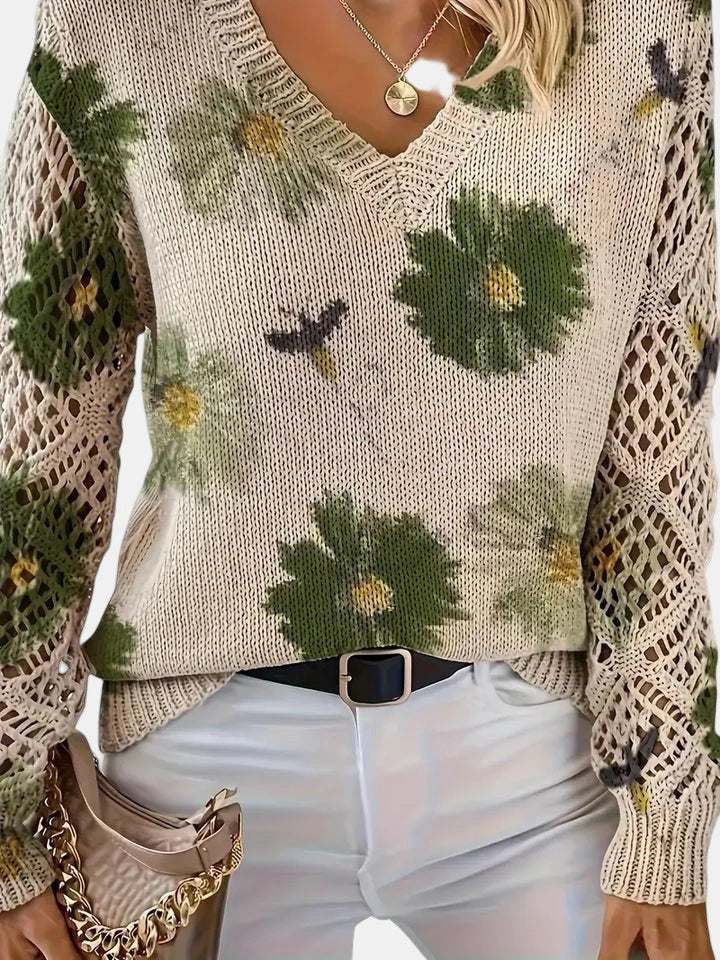 Close-up of a green floral v-neck long sleeve sweater showing the v-neck detail