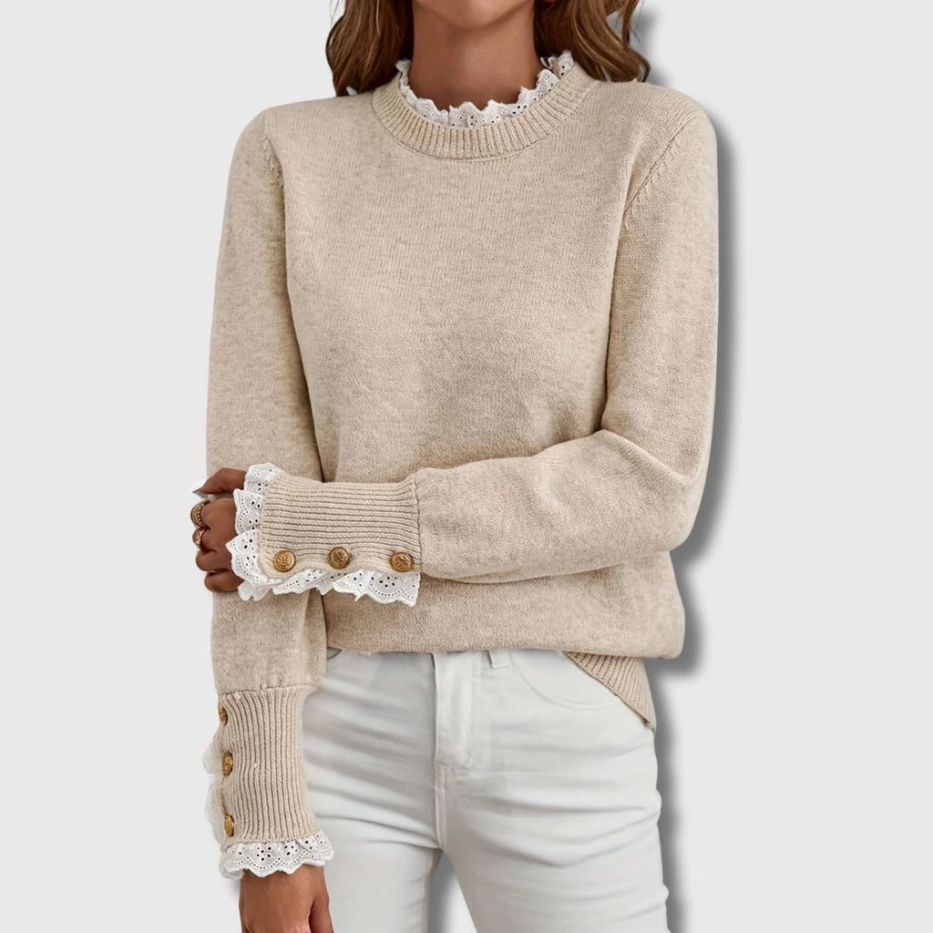 Woman wearing an apricot lace trim round neck long sleeve sweater in a studio setting