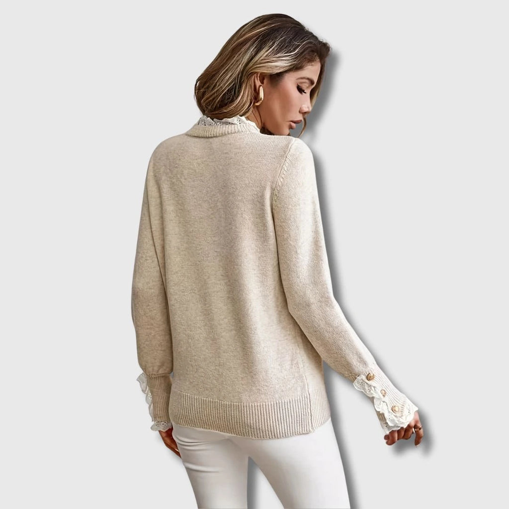 Close-up of an apricot lace trim round neck long sleeve sweater showing the lace detail