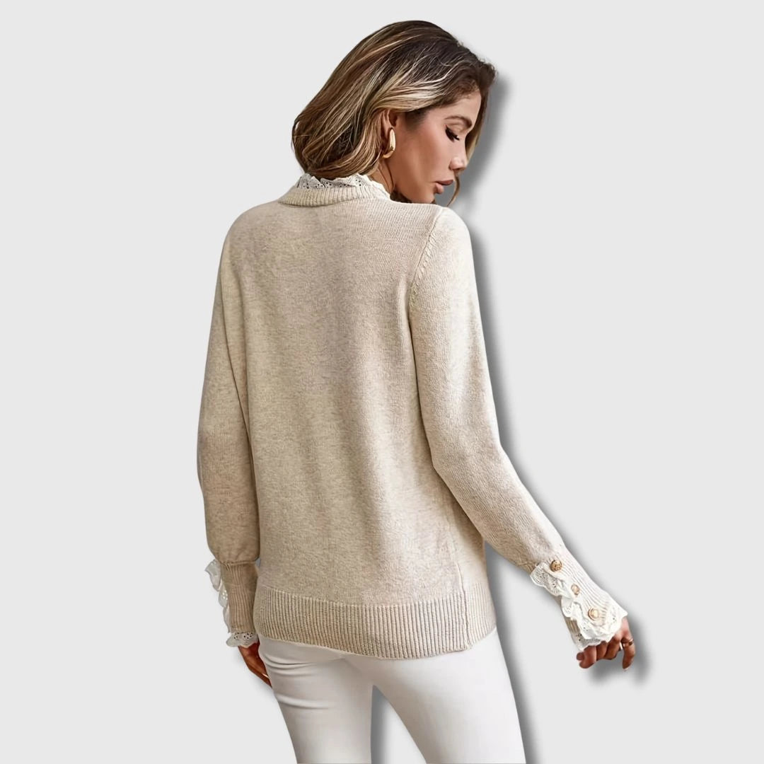 Close-up of an apricot lace trim round neck long sleeve sweater showing the lace detail