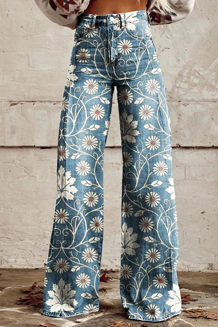 Woman wearing blue bohemian print wide-leg trousers with a white daisy floral pattern, front view