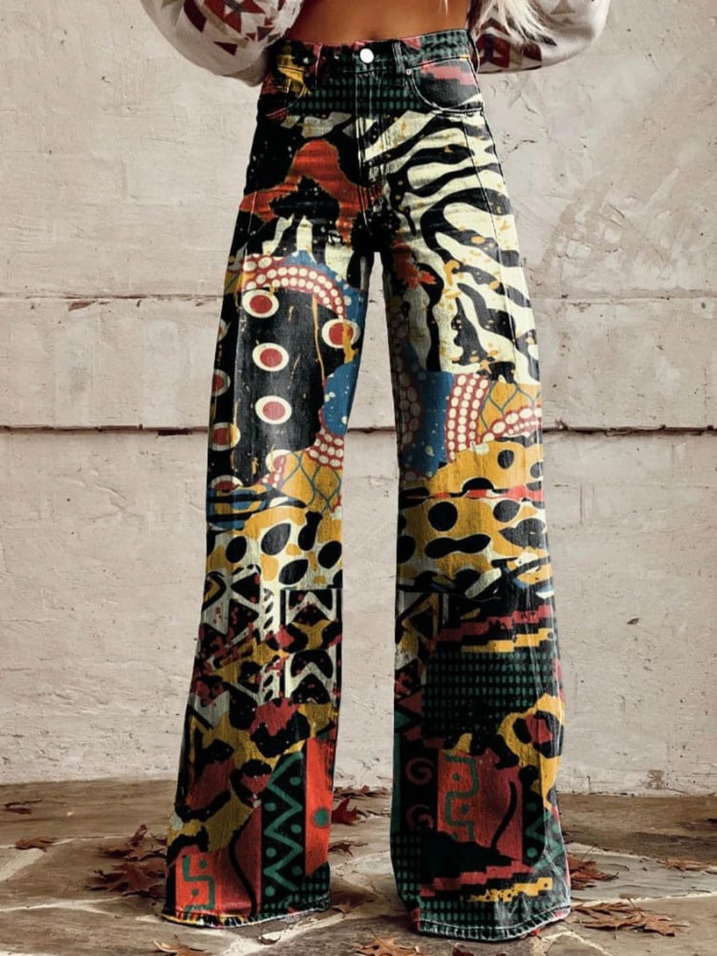 Close-up of black chic wide-leg trousers with a multicolor animal-print pattern, front view