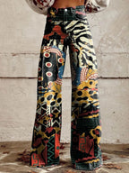 Close-up of black chic wide-leg trousers with a multicolor animal-print pattern, front view