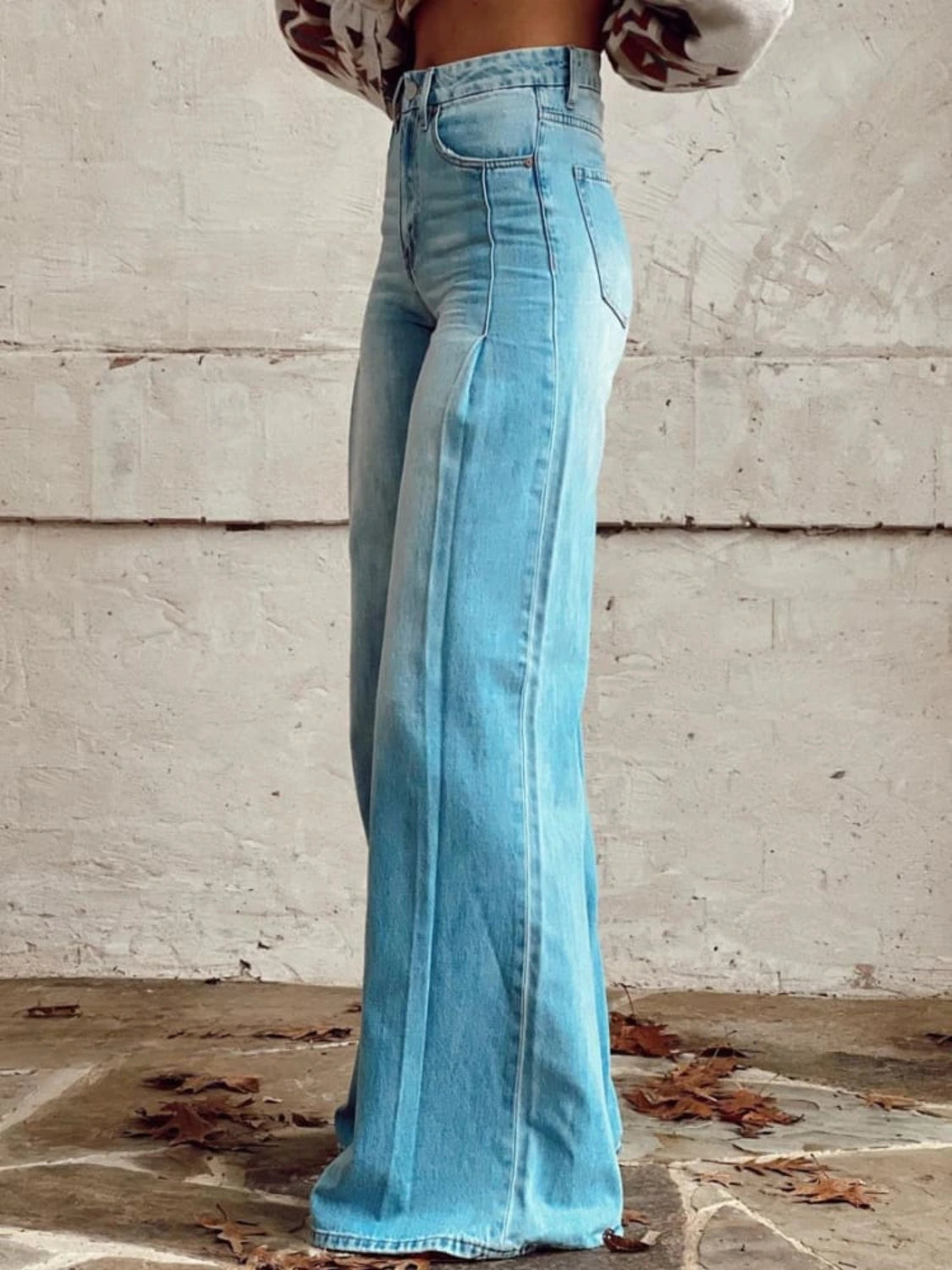 Woman wearing blue wide-leg trousers in a lifestyle setting