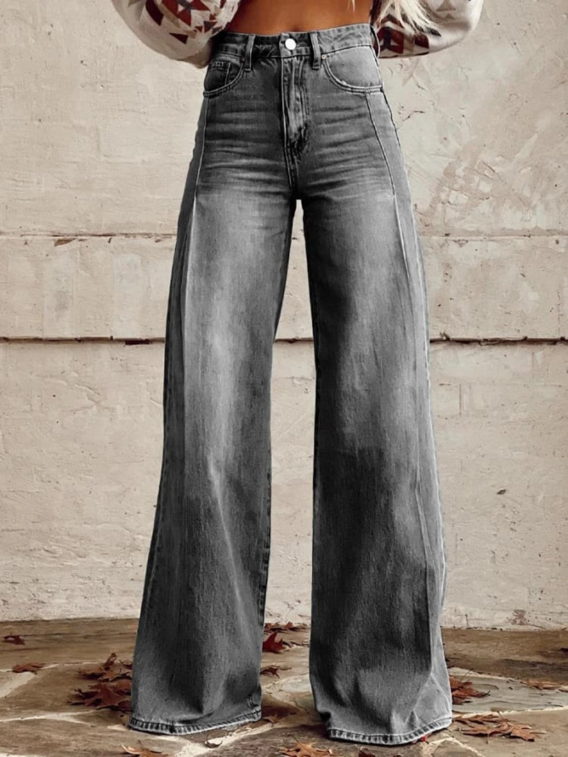 Woman wearing gray wide-leg trousers in a lifestyle setting