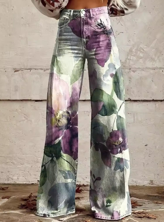 Close-up of purple floral print bohemian high-waisted wide-leg trousers on a light denim base