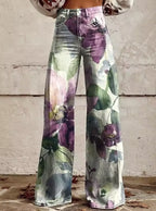 Close-up of purple floral print bohemian high-waisted wide-leg trousers on a light denim base