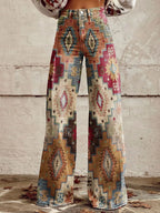 Woman wearing multicolor aztec-print brown vintage chic high-waisted wide-leg trousers, front view