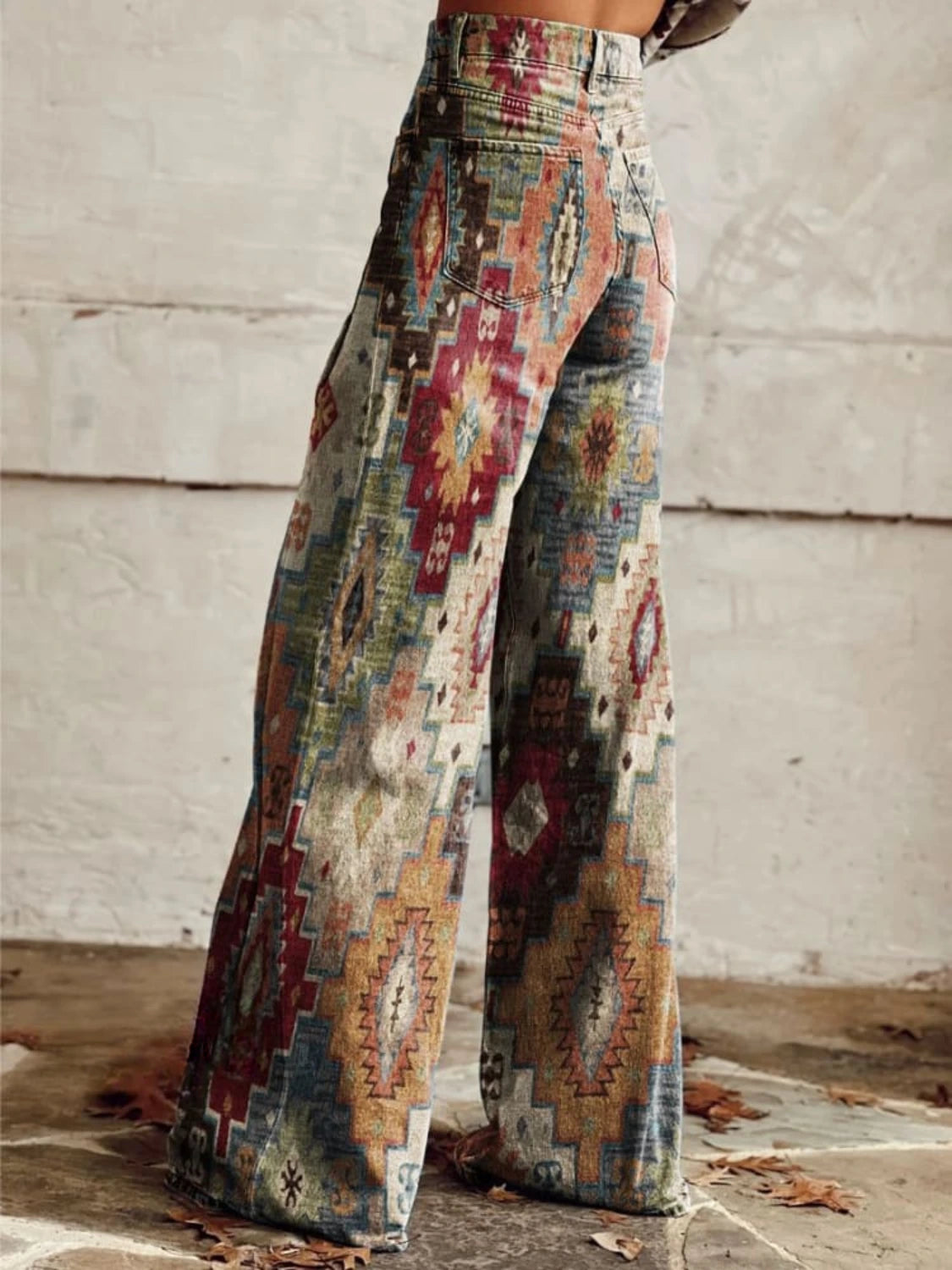 Woman wearing multicolor aztec-print brown vintage chic high-waisted wide-leg trousers, side view