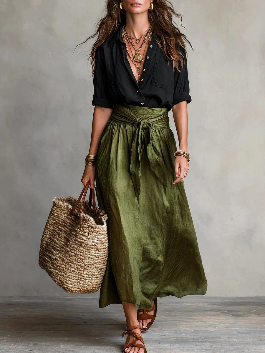 Woman wearing a black and olive green two-piece midi set in a studio setting