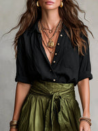 Close-up of a black and olive green two-piece midi set showing the color-block detail